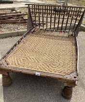An Oriental style bed base 19th century with rope woven base and decorative metal rails and