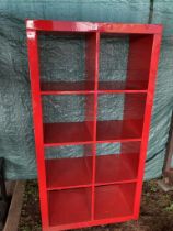 A red gloss effect 8 compartment shelf unit approximately 145 x 80w x 40d cm