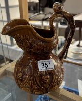 A vintage jug with figure head on handle