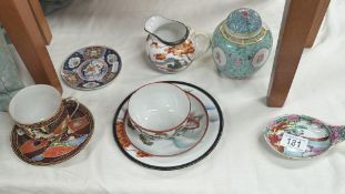 A selection of oriental China items including cups, saucers, spoon, ginger jar etc