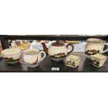 A quantity of Dartmouth & other pottery tea set items with thatched cottage slip design