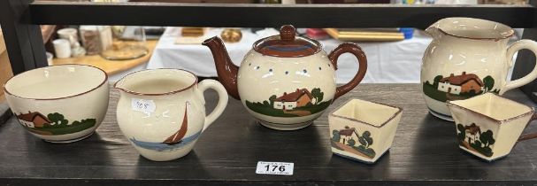 A quantity of Dartmouth & other pottery tea set items with thatched cottage slip design