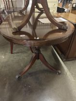 An inlaid oval double leg claw foot extending dining table