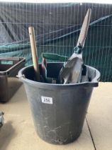 A quantity of gardening tools in a black plastic bucket