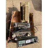 A vintage Dry Accumulator Charger plus three old car radios