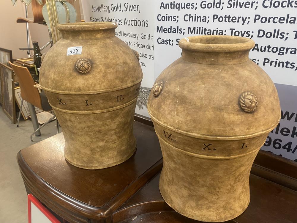 A pair of large unusual ceramic vases featuring Roman numerals