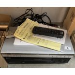 A VCR & DVD player with remote controls & manuals