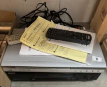 A VCR & DVD player with remote controls & manuals