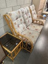A 3-piece cane conservatory suite. 1 Armchair & 2-seater. With glass top side table