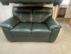 A green leather 2 seat settee