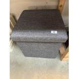 An upholstered foot stool / storage box