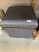 An upholstered foot stool / storage box