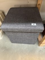 An upholstered foot stool / storage box