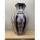 A large gilded and coloured vase