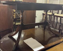 An oval double pillar claw & foot dining table