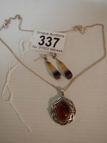 A silver pendant set amber? and a pair of pendant earrings.