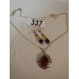 A silver pendant set amber? and a pair of pendant earrings.