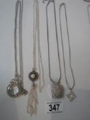A quantity of necklaces including magnifying glass pendant.