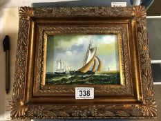A gilt framed study a ship at sea