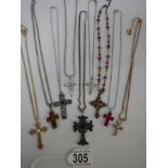 Nine assorted cross pendants.