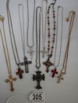 Nine assorted cross pendants.