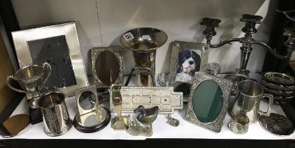 A shelf of sliver and sliver plated items