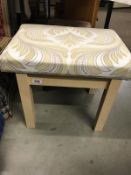 A stool with upholstered top