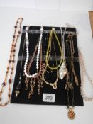Twelve good vintages necklaces and pendants.