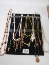 Twelve good vintages necklaces and pendants.