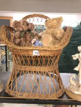 A wicker chair with teddies