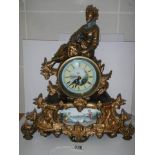 A good 20th century mantel clock surmounted figure and with handpainted dial and panel, with battery