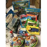 A collection of Thomas the Tank Engine items including spinning tops and puzzles