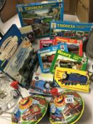 A collection of Thomas the Tank Engine items including spinning tops and puzzles