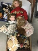 A collection of porcelain dolls and teddies