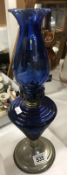 A Oil lamp with blue glass shade