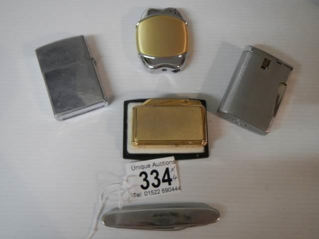 Four vintage cigarette lighters including Colibri and a penknife.