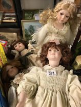 A collection of four porcelain dolls