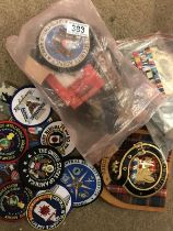 A quantity of military badges and family crest