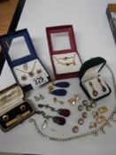 A mixed lot including pendants with matching earrings, sets of buttons etc.,