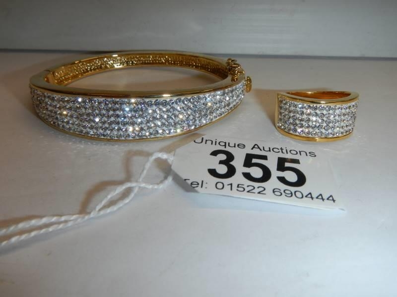 A good quality yellow metal sparkly bangle with matching ring.