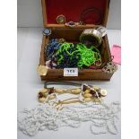 A jewellery box containing assorted costume jewellery.