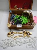 A jewellery box containing assorted costume jewellery.