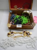 A jewellery box containing assorted costume jewellery.