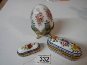 Two porcelain patch boxes and an egg shaped trinket box.