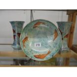 An unusual Burleigh ware bowl decorated with fish and a pair of matching vases.