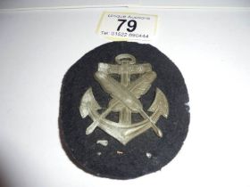 An old cloth naval badge with metal back.