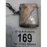 A hall marked silver vesta case with gold (375) mounts, in good condition.