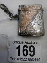 A hall marked silver vesta case with gold (375) mounts, in good condition.