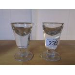 Two Victorian glass 'Penny Lick' glasses.