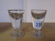Two Victorian glass 'Penny Lick' glasses.